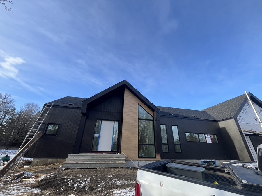 New construction with dark vertical siding
